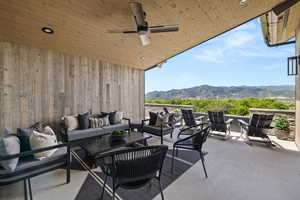 View of patio featuring an outdoor living space, a mountain view, and ceiling fan