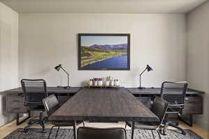 Office with wood finished floors and baseboards
