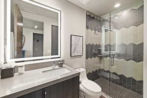 Full bathroom featuring a shower stall, vanity, and recessed lighting