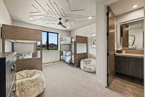 Bedroom featuring carpet, recessed lighting, and ensuite bath