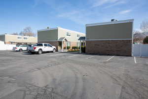 Uncovered parking lot featuring fence