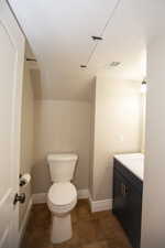 Bathroom featuring visible vents, baseboards, toilet, tile patterned floors, and vanity