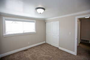 Bedroom with carpet flooring, new paint, baseboards, and visible vents