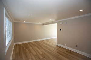 Family room with recessed lighting, new LVP flooring, baseboards, and ornamental molding