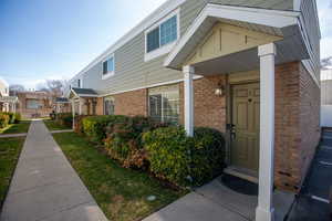 Property entrance with brick and siding