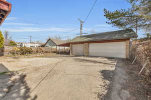 Detached garage featuring fence