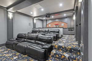 Carpeted cinema room with ornamental molding, recessed lighting, and beam ceiling