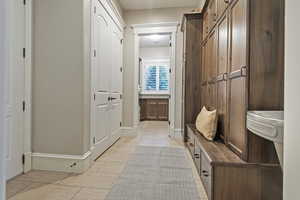 Mudroom featuring light tile patterned flooring