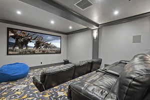 Cinema featuring crown molding and recessed lighting