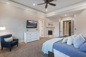 Carpeted bedroom with crown molding, a brick fireplace, baseboards, and recessed lighting