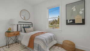 Bedroom featuring baseboards and wood finished floors