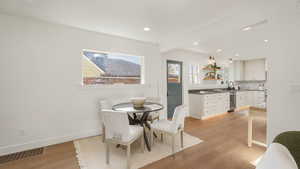 Dining area with baseboards, visible vents, beam ceiling, recessed lighting, and light wood-type flooring