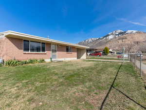 View of yard featuring a mountain view and fence