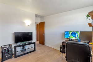 Bedroom space featuring baseboards and  light wood-style floors