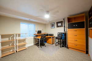 Office space featuring baseboards, carpet, and a ceiling fan