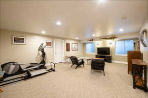 Exercise room featuring recessed lighting, a healthy amount of sunlight, and light carpet