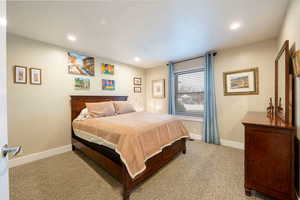 Bedroom featuring recessed lighting, carpet, and baseboards