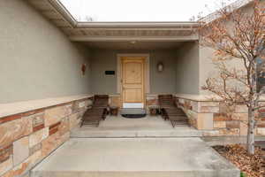 View of exterior entry featuring stucco siding