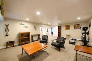 Living area featuring carpet flooring, recessed lighting, and baseboards