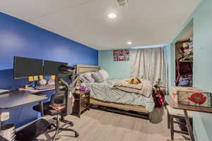 Bedroom with recessed lighting, visible vents, and wood finished floors