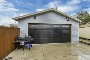Detached garage featuring fence