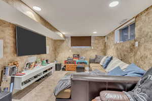 Carpeted living room with recessed lighting