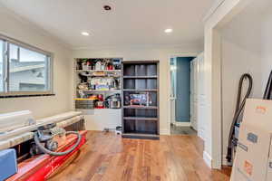 Game room featuring recessed lighting, crown molding, and wood finished floors