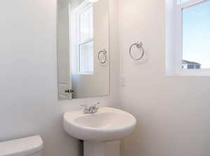 Half bathroom with toilet and a sink
