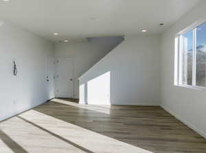 Unfurnished room with recessed lighting, wood finished floors, and baseboards