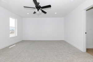 Unfurnished room featuring recessed lighting, ceiling fan, light colored carpet, and baseboards