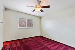 Unfurnished room featuring a ceiling fan, carpet flooring, visible vents, and baseboards