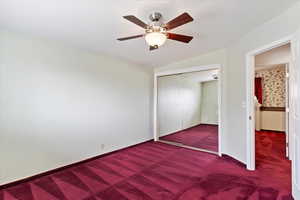 Unfurnished bedroom featuring baseboards, carpet, a closet, and ceiling fan