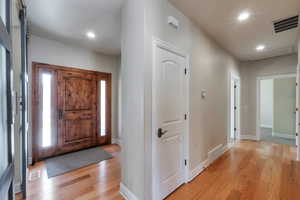 Entryway with light wood-style flooring, recessed lighting, and visible vents