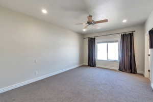 Unfurnished room featuring a ceiling fan, recessed lighting, light colored carpet, and baseboards