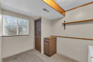 Bar featuring visible vents and light colored carpet