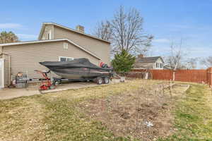 View of home's exterior featuring a lawn and fence