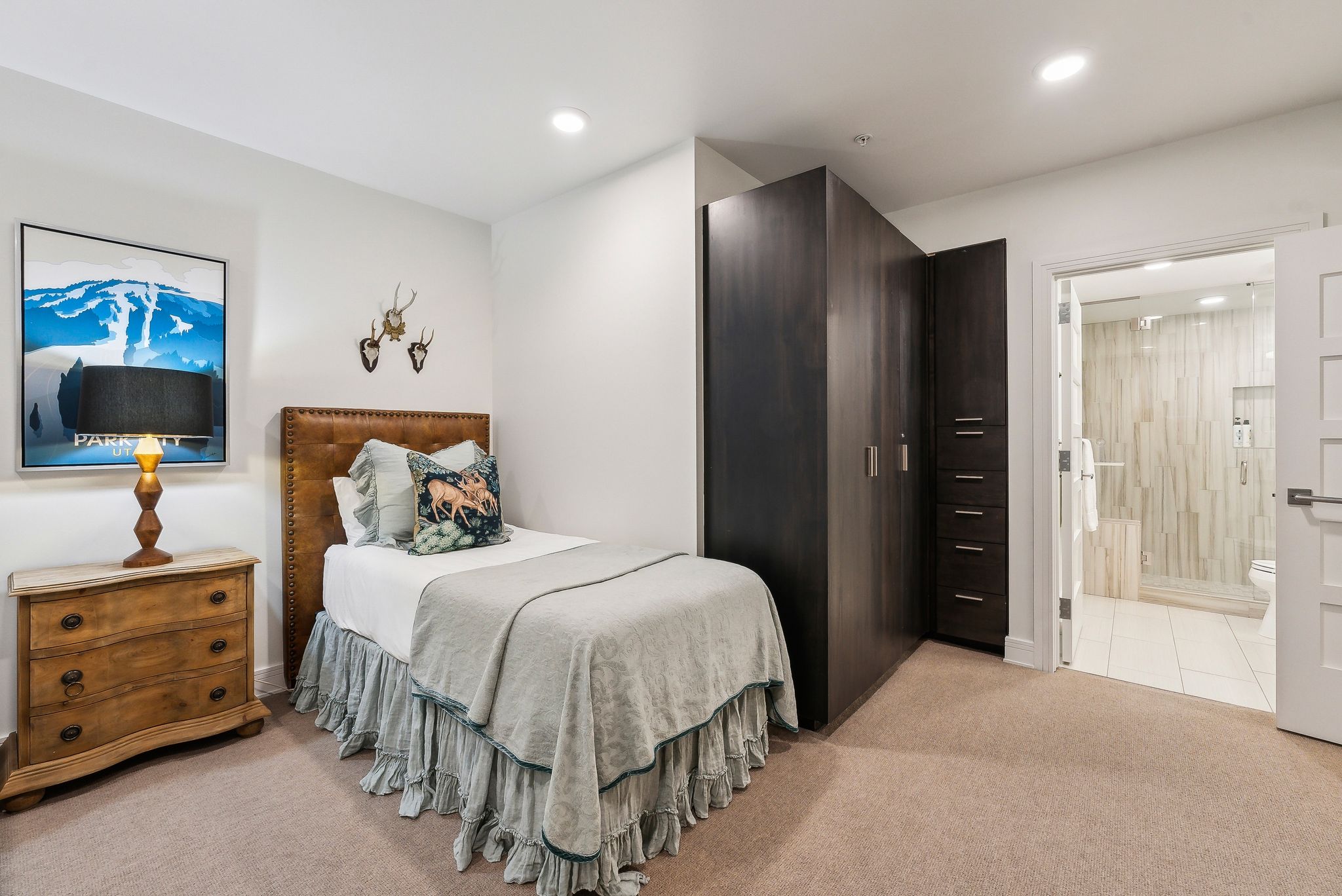 Bedroom with recessed lighting, light colored carpet, and ensuite bath