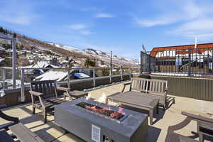 View of patio / terrace featuring a fire pit and a mountain view