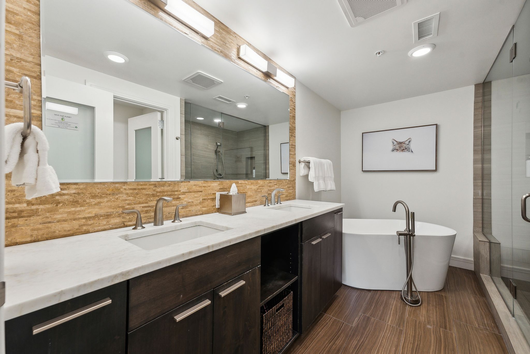 Full bath with a shower stall, visible vents, and a sink