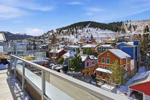 Snow covered back of property featuring a mountain view