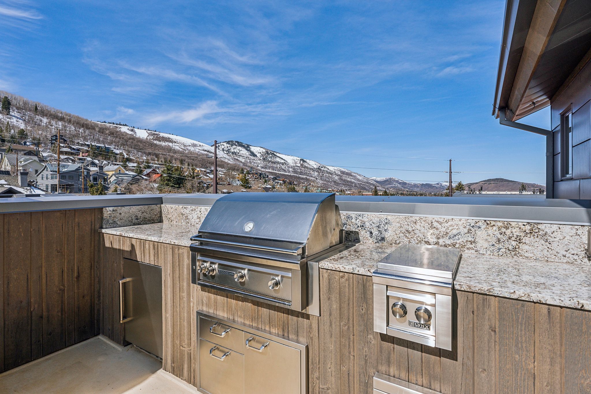 View of patio / terrace featuring exterior kitchen, area for grilling, and a mountain view