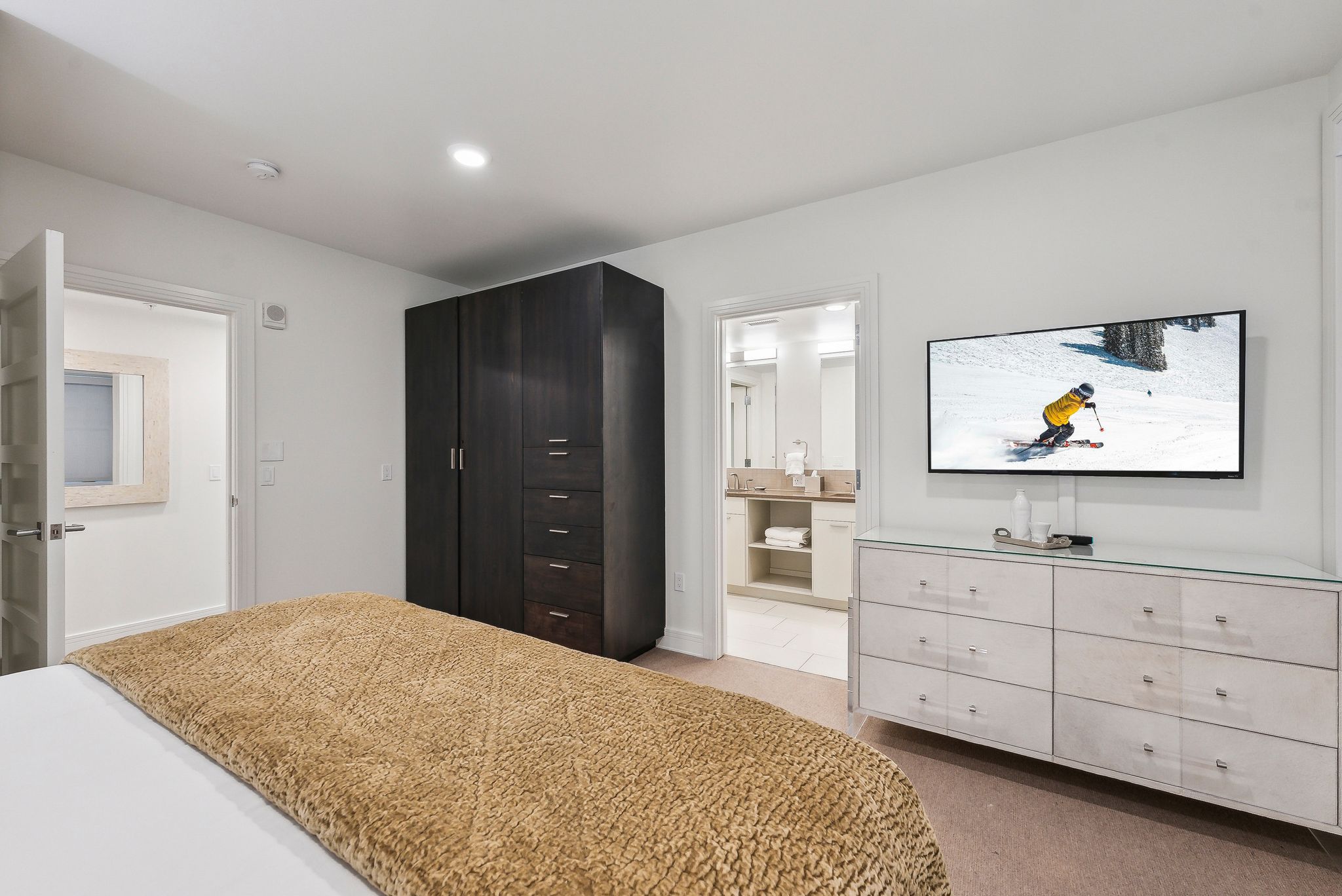 Carpeted bedroom featuring recessed lighting and ensuite bath