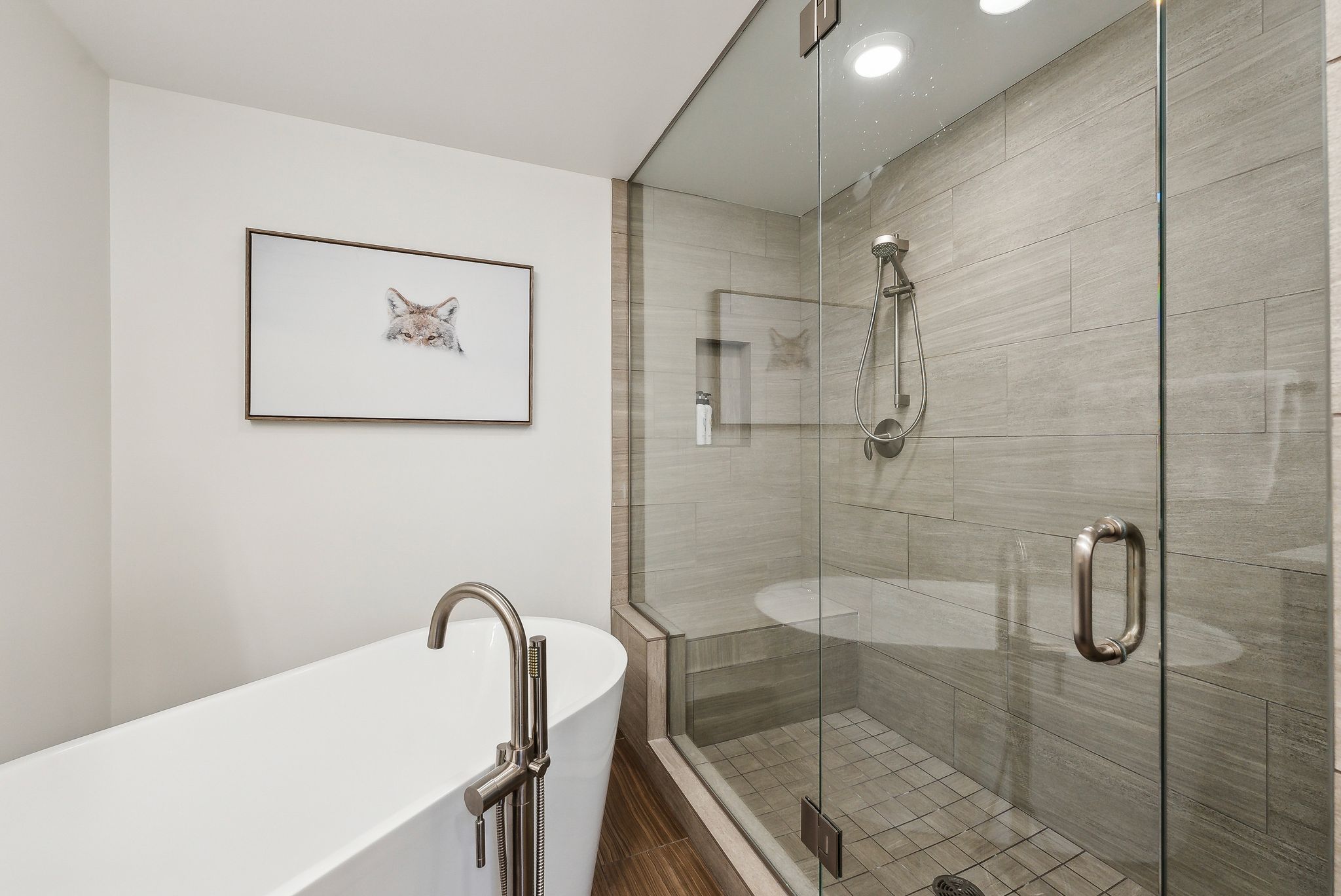 Bathroom with a freestanding bath and a shower stall