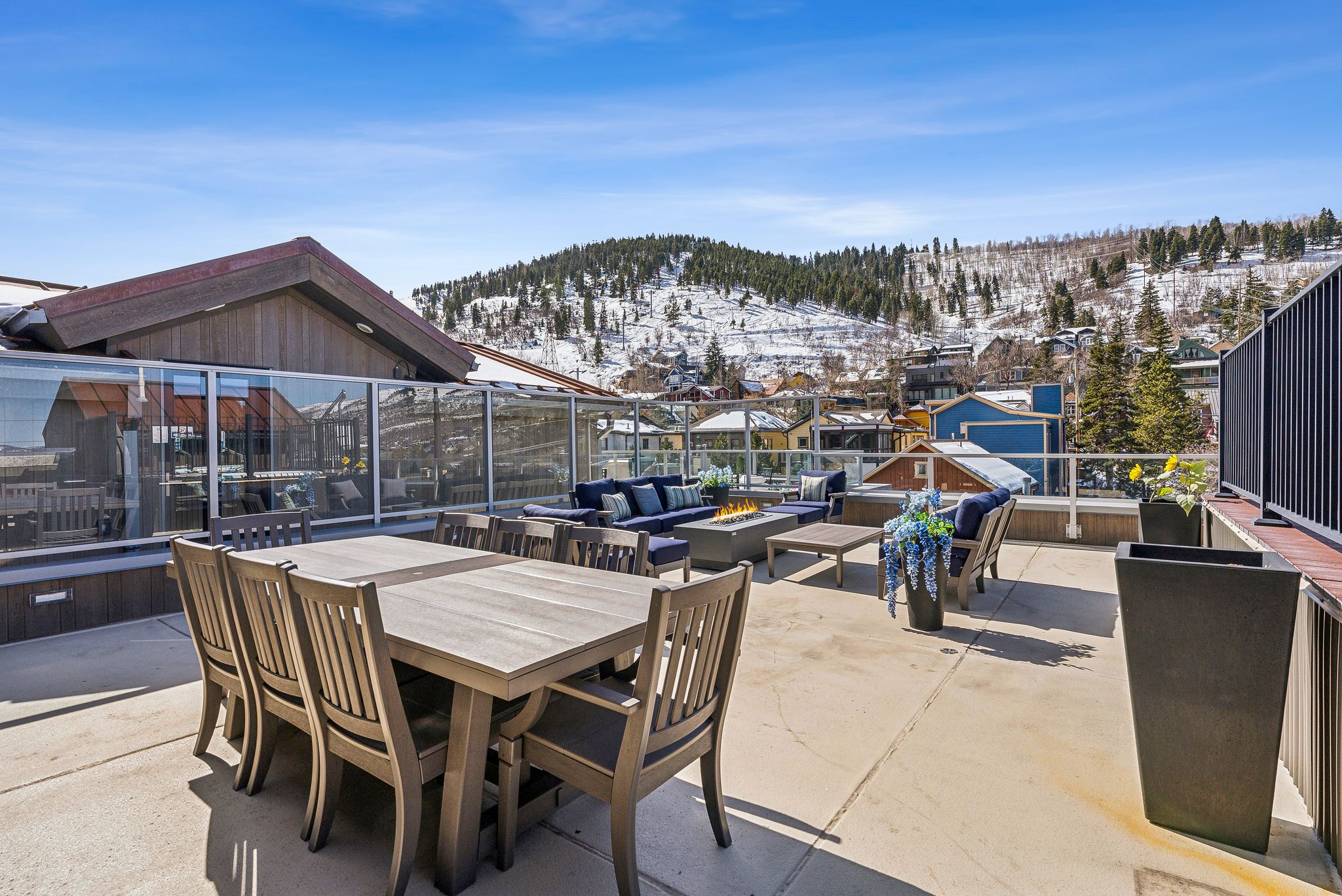 View of patio featuring a mountain view, an outdoor living space with a fire pit, and outdoor dining space