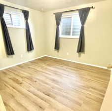 Bedroom featuring baseboards and wood finished floors