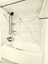 Full bath featuring shower / tub combination