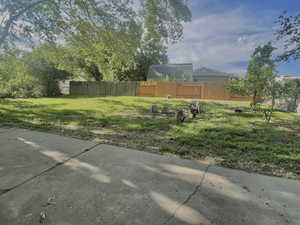 View of yard featuring fence
