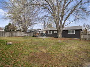 View of yard with a fenced backyard and a patio