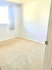 Bedroom with carpet=and baseboards