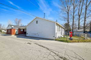 View of side of property with brick siding and fence